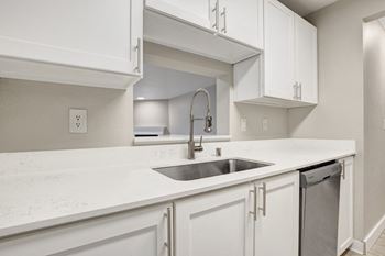 a spacious kitchen with white cabinets and a sink at 2000 Lake Washington Apartments, Renton, WA